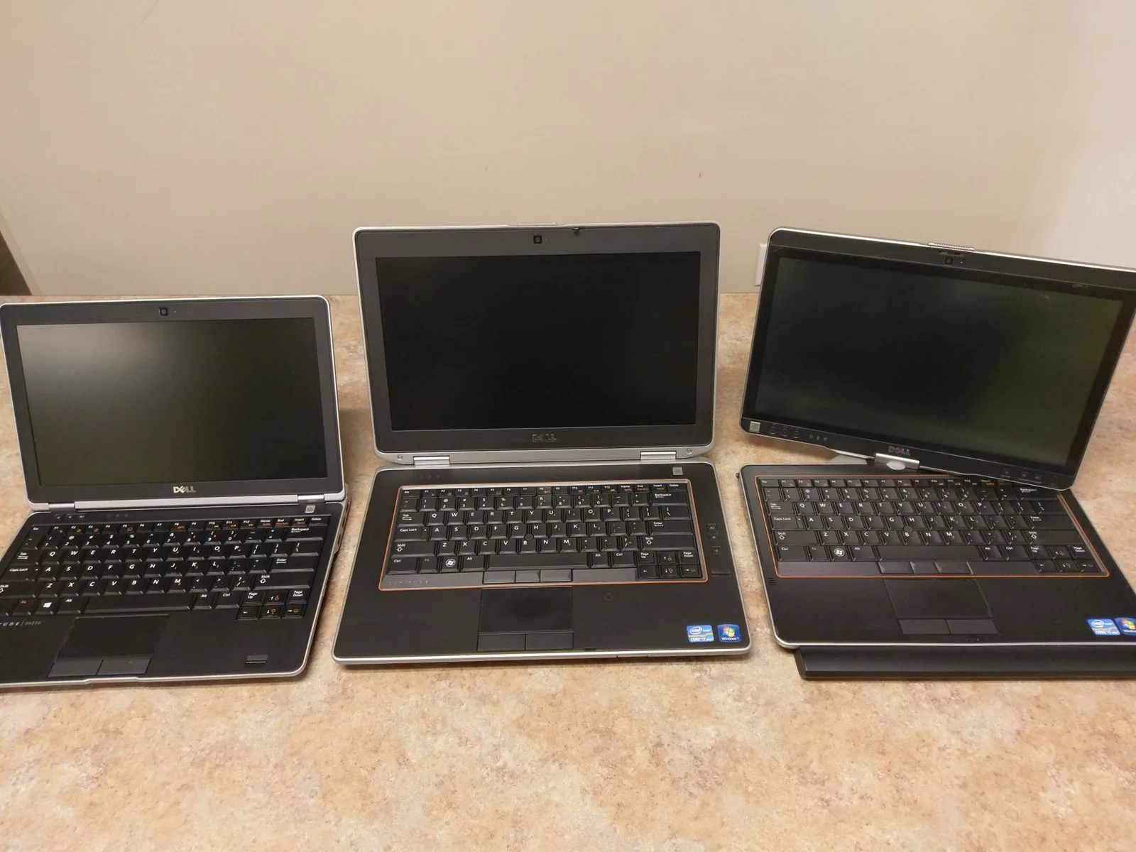 Row of business laptops lined up on a service counter