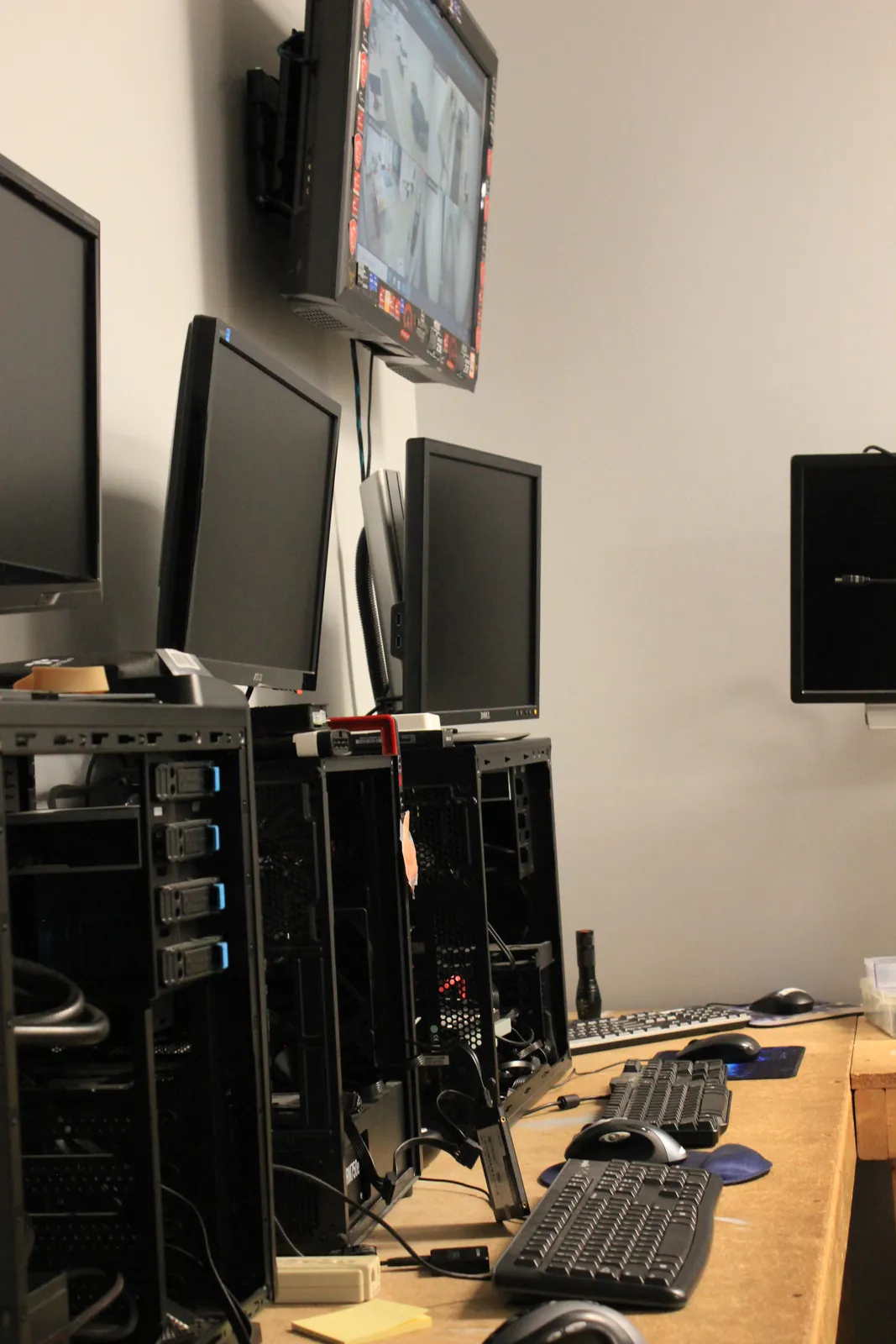 Row of open desktop towers and monitors on the Computer Ties workbench