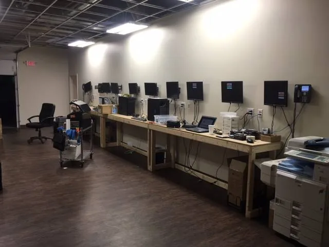 Desktop computer workstations staged on a workbench for setup