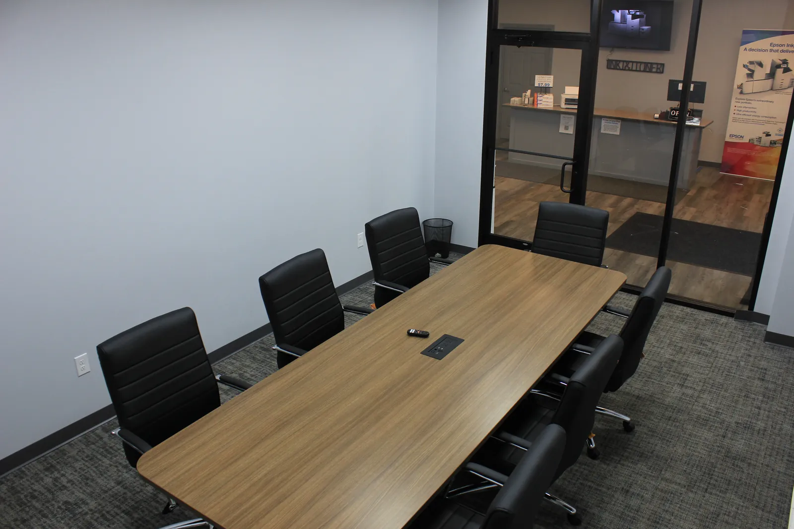 CTi Tech Plaza conference room with long wood table and black leather chairs