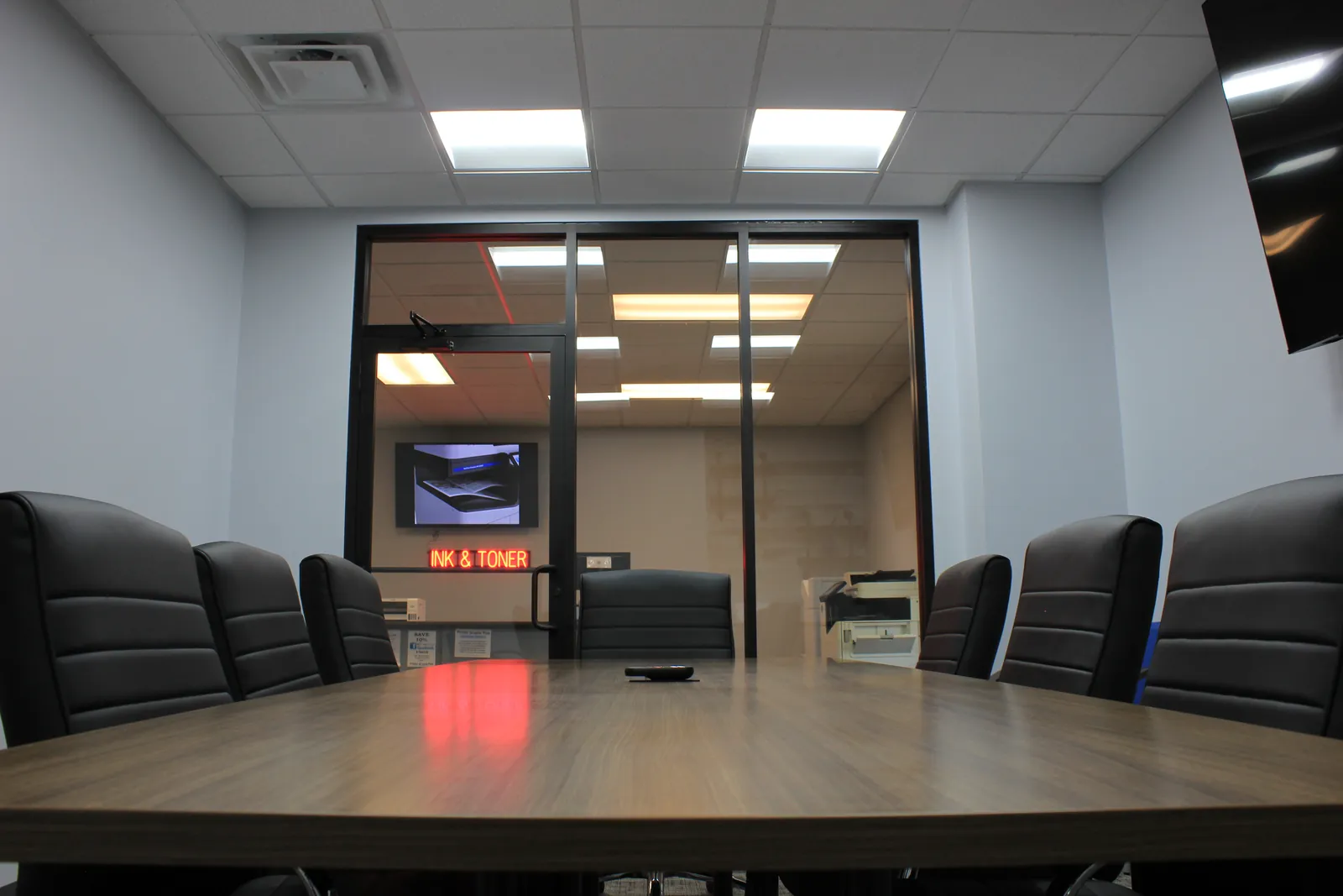CTi Tech Plaza conference room table looking out through glass walls to the lobby